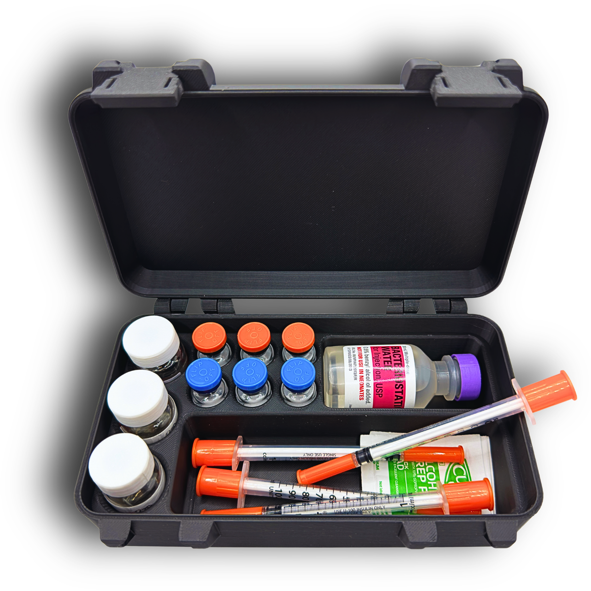 Open storage case fully loaded with three 10ml vials, six 3ml vials, a larger BAC water vial, syringes, and alcohol wipes. Compartments keep all items upright and separated for secure transport. Black snap-lock case ideal for TRT, HRT, GLP-1, insulin, and general wellness routines at home, in a gym bag, or during travel.