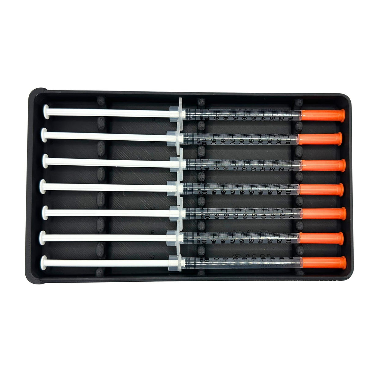 Image 1 (Black-3, top-down full): Weekly prefilled syringe organizer holds seven 1ml insulin syringes in black storage case, top-down view showing all 7 slots with numbered day-of-week labels and raised dividers. Syringe holder for TRT, GLP-1, insulin, daily dose prep. Compact syringe travel case fits fridge drawer or bag.