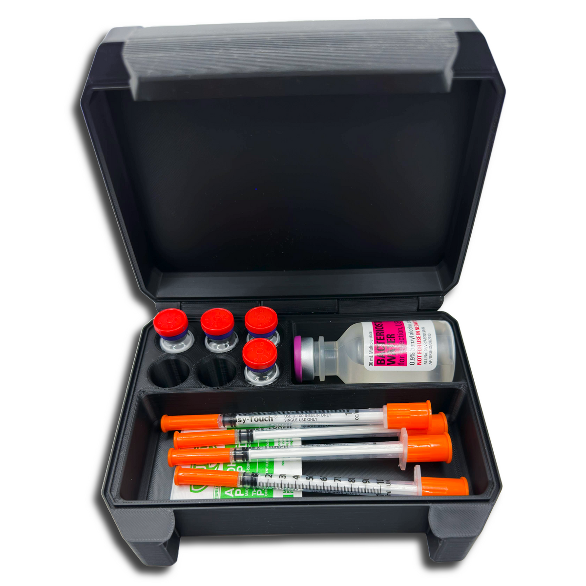 Black storage case with medical supplies including syringes and vials on a white background