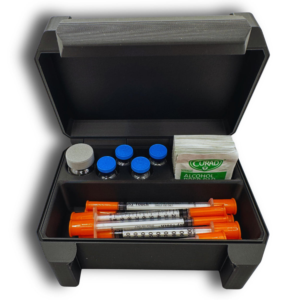 Front view of a black compact vial travel case with demonstration vials, syringes and prep pads in separate compartments.