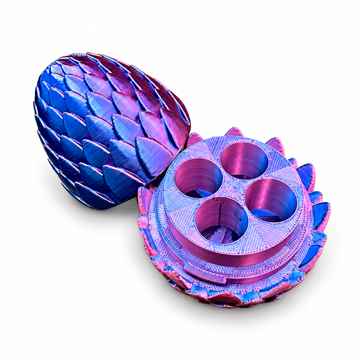 Open dragon egg vial holder showing four empty round vial slots and the removable scale-patterned lid beside the base.