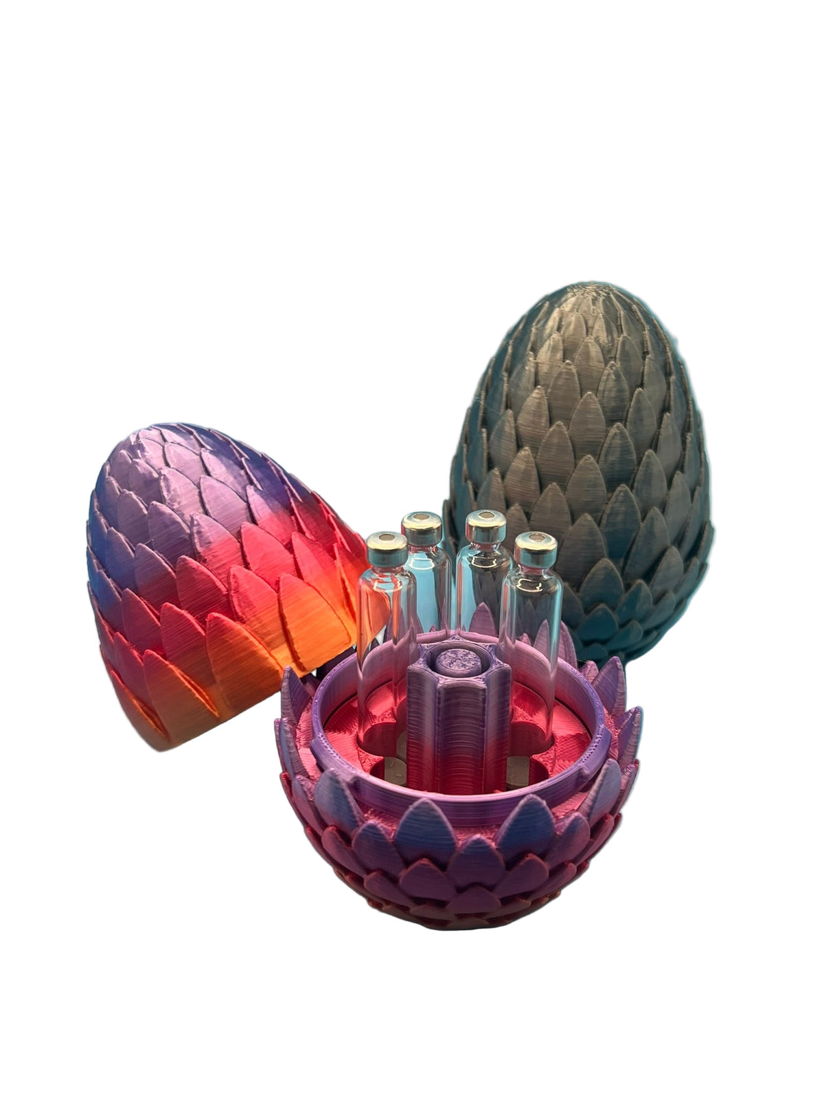 Dragon egg-style cartridge holders in multiple colors, with one open to display seven 3ml glass cartridges arranged around a central purge tower.