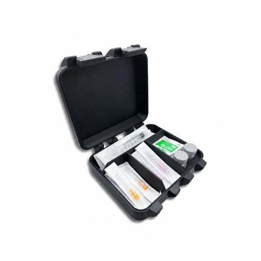 Angled view of an open black two-slot 10ml vial storage case on white, with syringes, packaged needles, prep wipes and two capped vials organized in divided compartments.