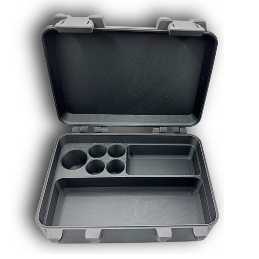 Empty vial and syringe organizer case displayed open to show interior layout. Includes precision fit slots for one 10ml vial, four 3ml vials, a larger vial slot, and a wide compartment for syringes or accessories. Compact hinged case design.
