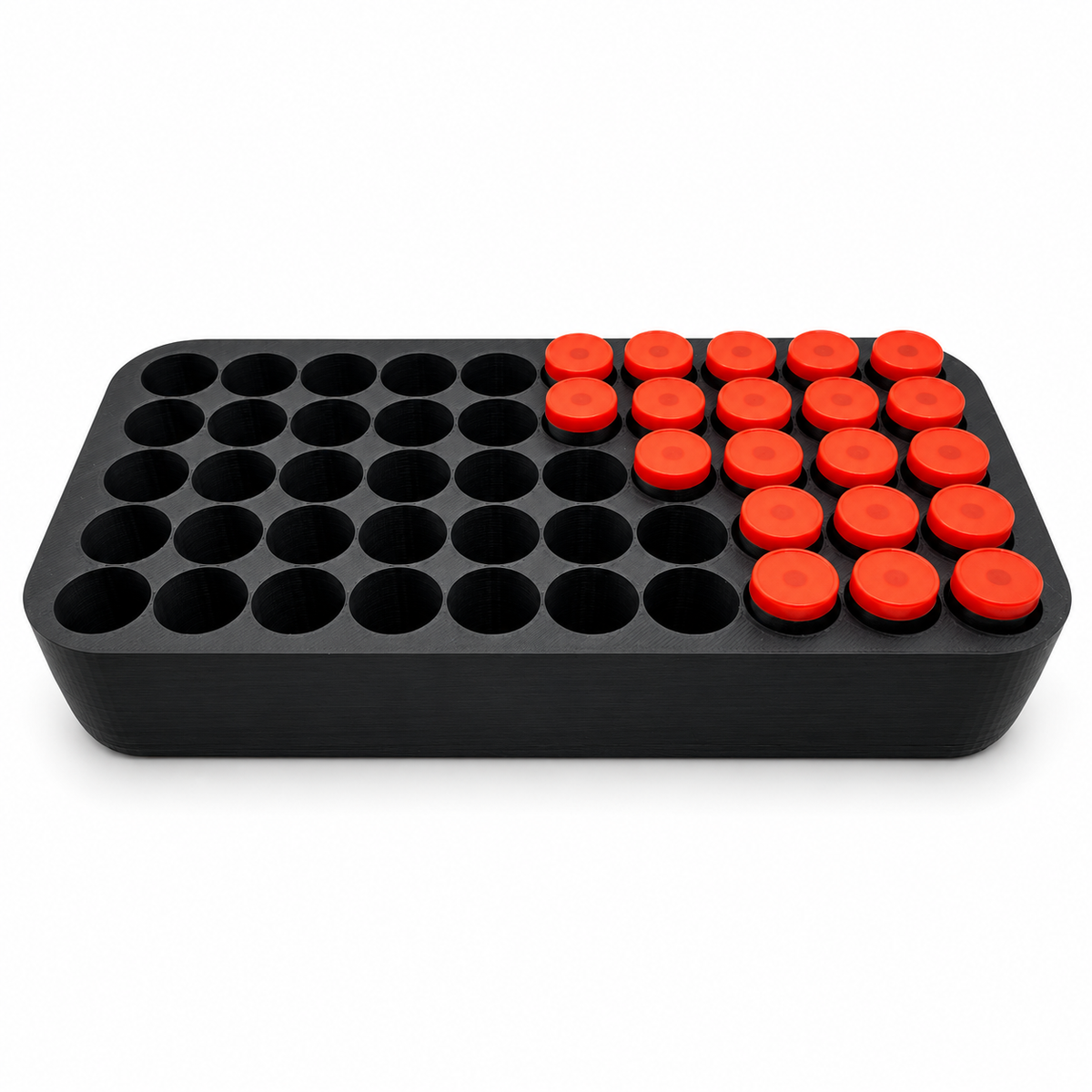 Black 50-slot vial insert partially loaded with orange-capped demonstration vials, showing individual positions for compatible 3ml bottles.