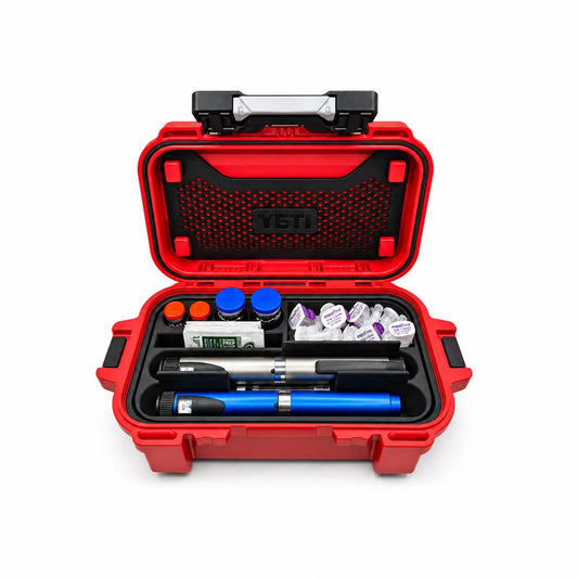 Black injection pen and vial organizer insert inside an open red YETI GoBox 1, holding two demonstration pens, four vials, pen needles and alcohol prep wipes. Insert only; case and supplies excluded.